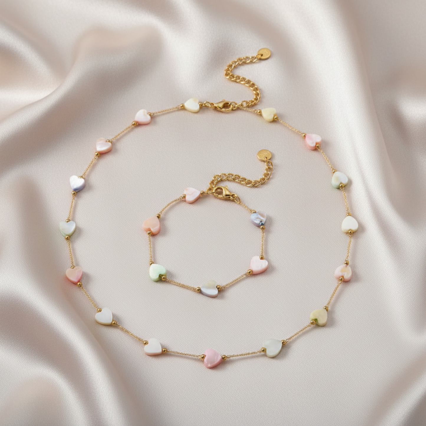 Necklace and bracelet set with heart-shaped beads on a satin background