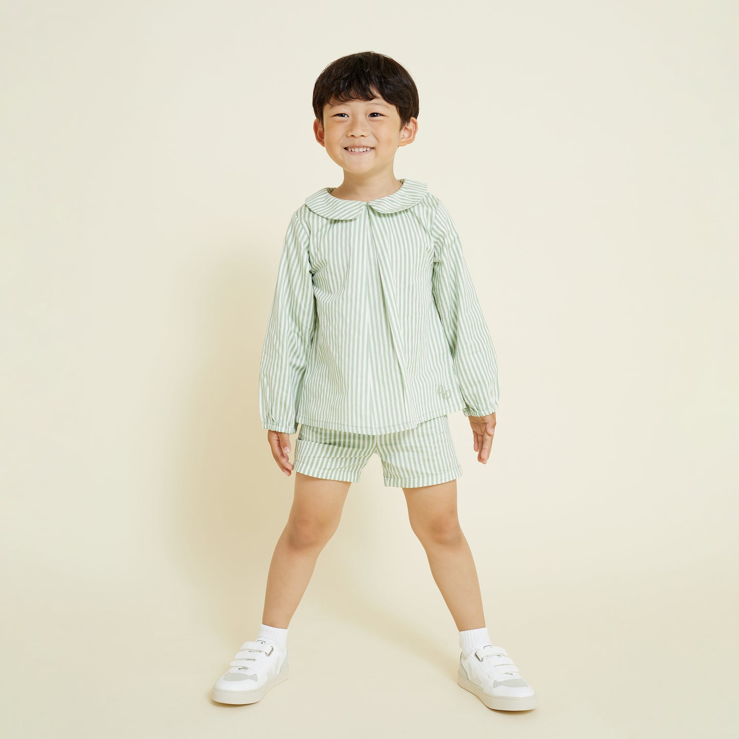 5 year old boy wears matching collared shirt and casual short in stripe