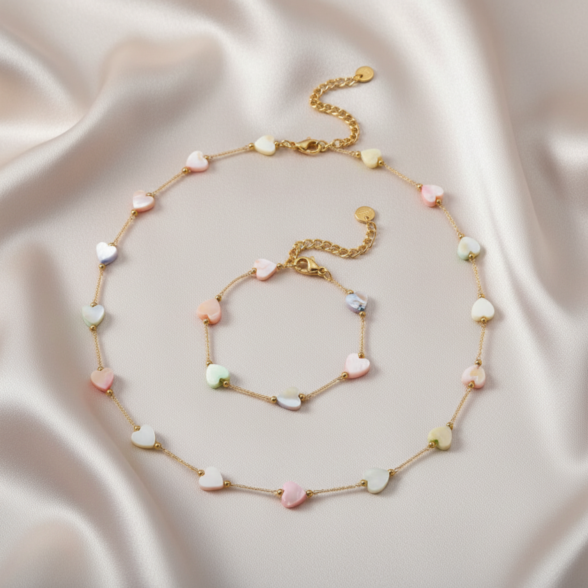 Necklace and bracelet set with heart-shaped beads on a satin background