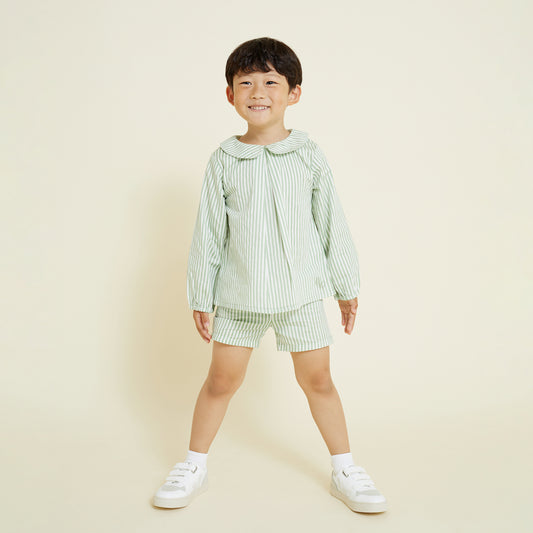 5 year old boy wearing casual pull on short in sage and milk white stripe, paired with collared shirt in a matching set