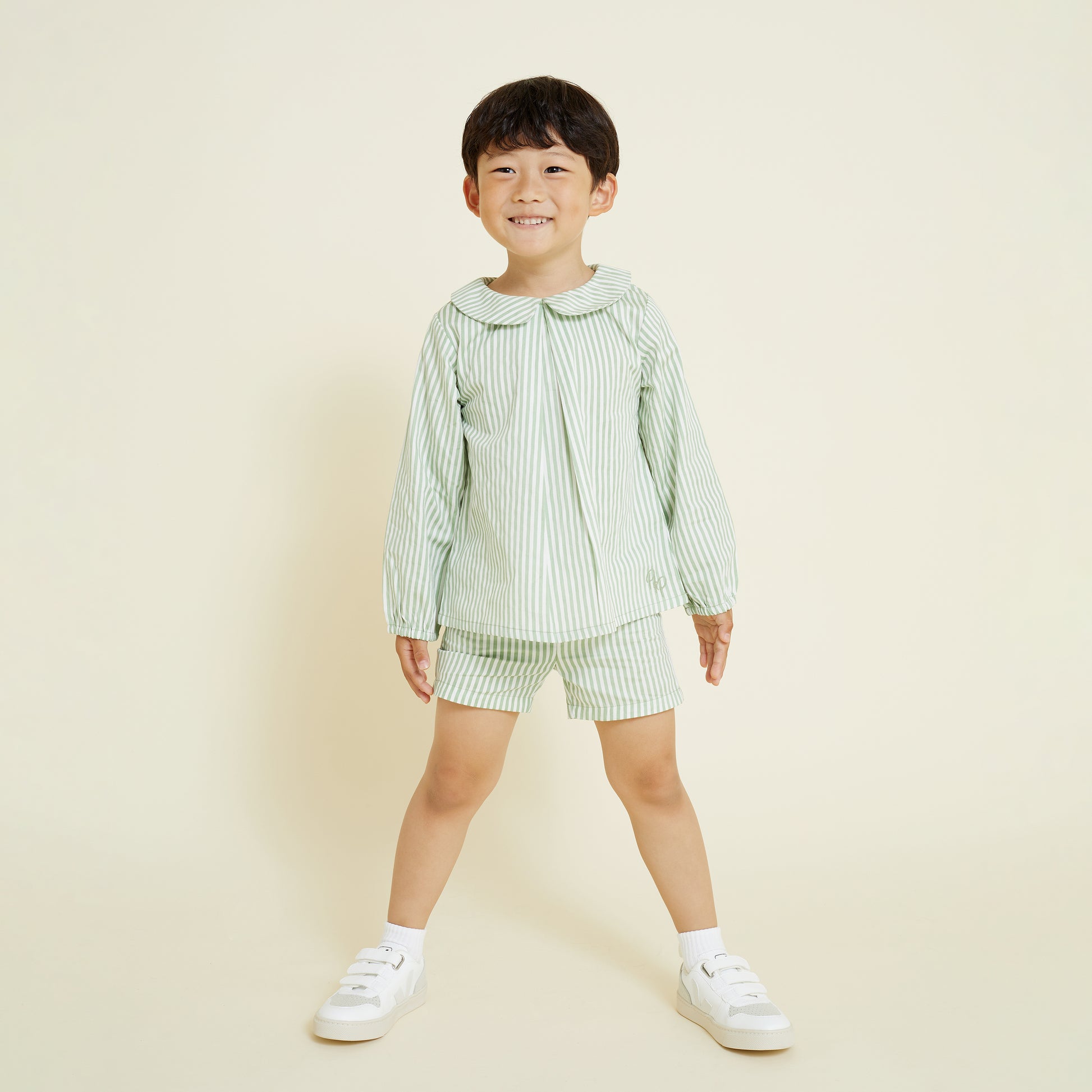 5 year old boy wears matching collared shirt and casual short in stripe