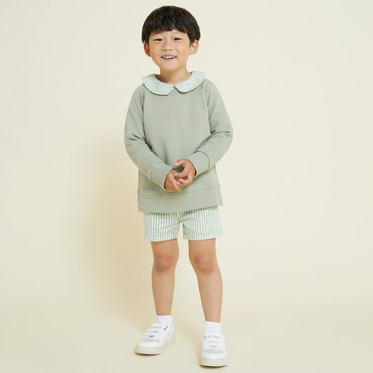 5 year old boy wears sage green sweatshirt, paired with collared shirt and matching shorts