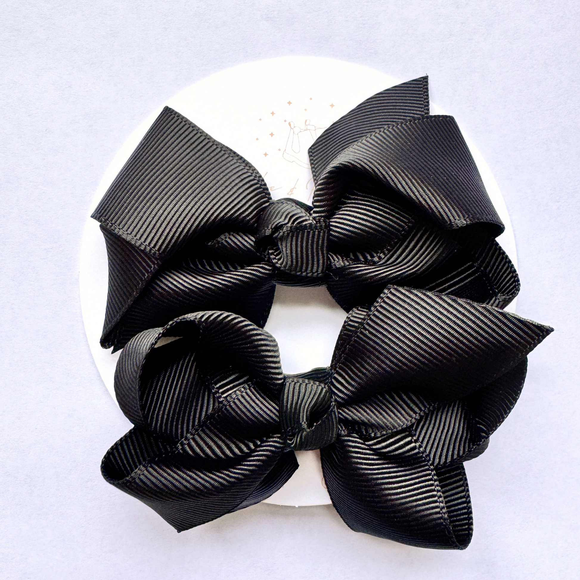 Mini Hair Bows in Black on the branded backing card