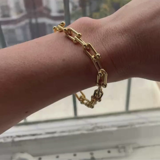 Video of gold chain bracelet on wearers wrist